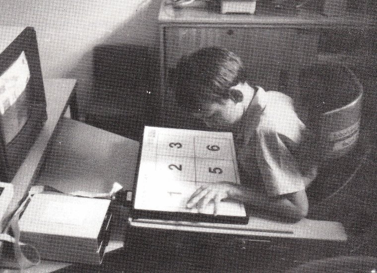 A child pressing a Concept Keyboard's overlay of large numbers